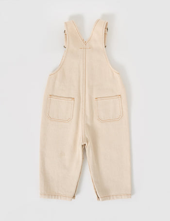 The Goldie + Ace Austin Denim Overalls in Oat pictured on a grey background. The material is cotton denim. It is a overall made for babies, toddlers and kids.