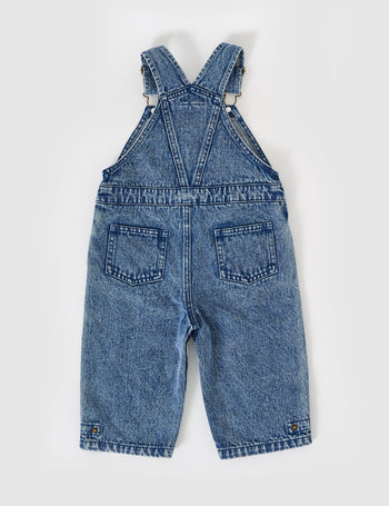 The Goldie + Ace Blake Vintage Washed Denim Overalls in Dark Denim pictured on a grey background. The material is cotton denim. It is a overall made for babies, toddlers and kids.