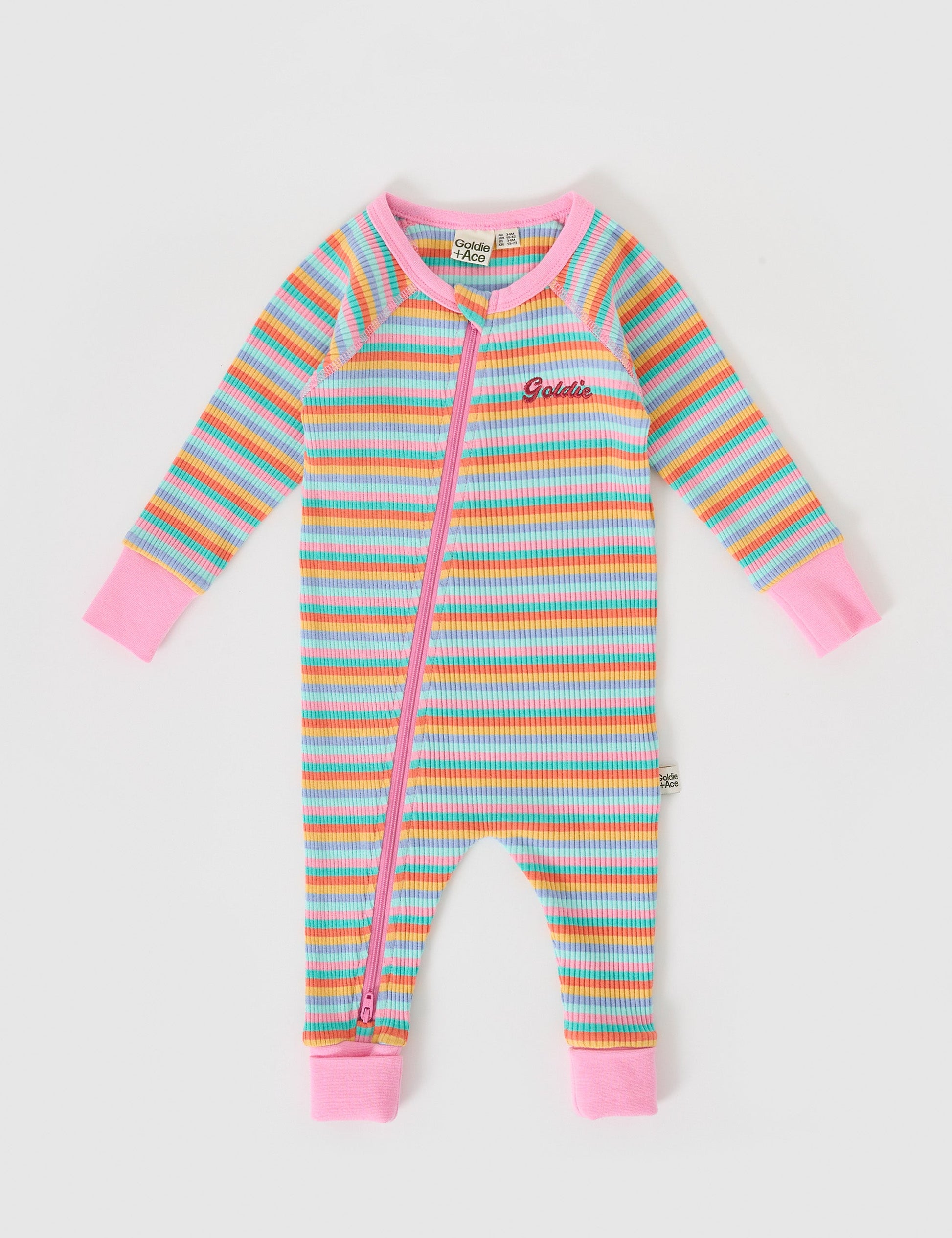 The Goldie + Ace Rib Zipsuit in Candy Stripe pictured on a grey background. The material is soft ribbed cotton elastane. It is a babywear made for babies, toddlers and kids.