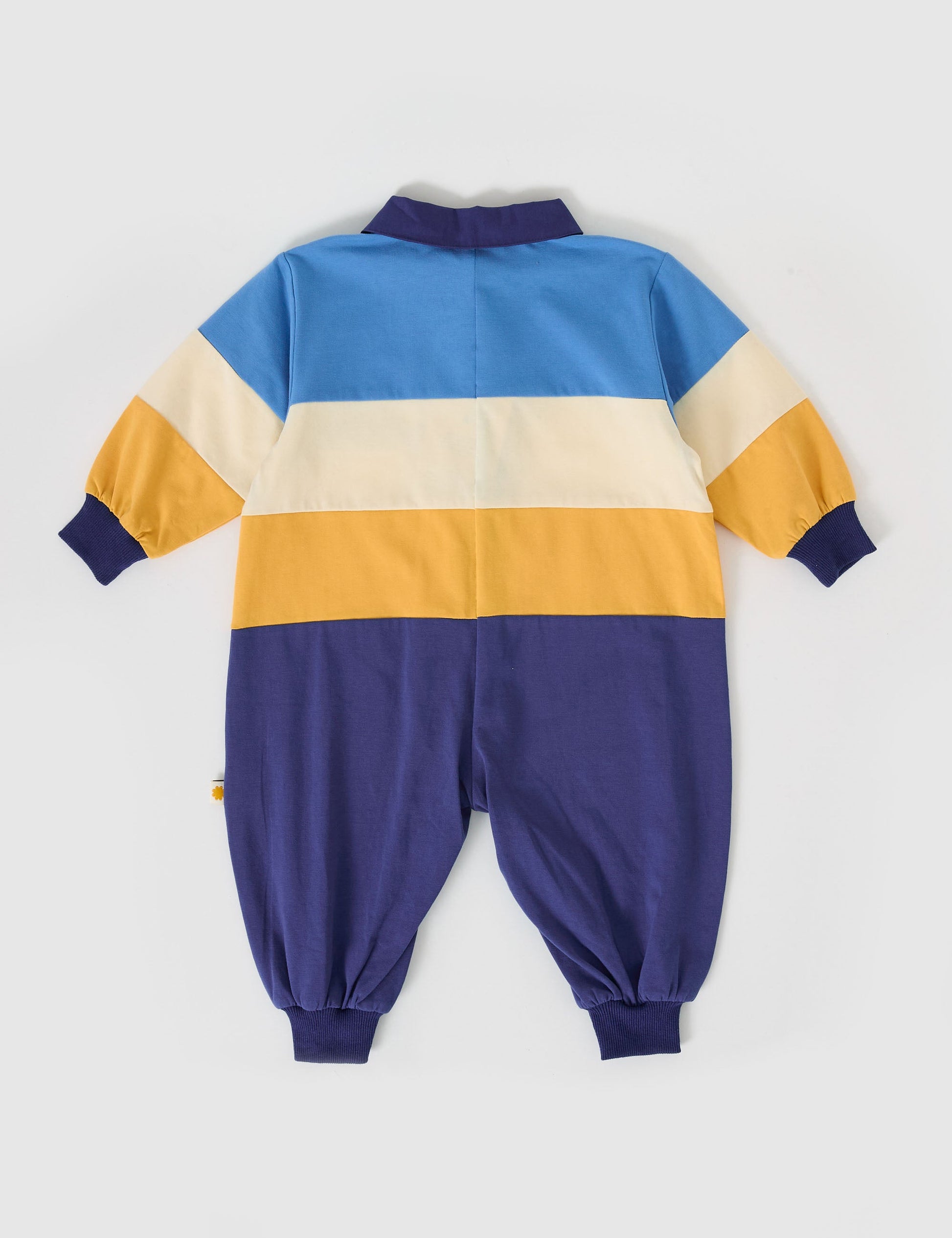 The Goldie + Ace Panelled Rugby Romper in Blue/Golden pictured on a grey background. The material is cotton jersey. It is a romper made for babies, toddlers and kids.