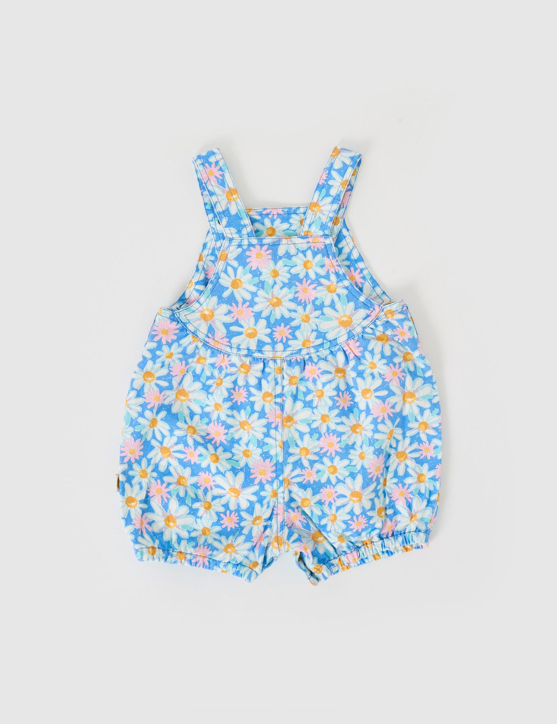 The Goldie + Ace Seaside Daisy Bessie Bubble Shortalls in Seaside Daisy pictured on a grey background. The material is cotton twill. It is a overall made for babies, toddlers and kids.