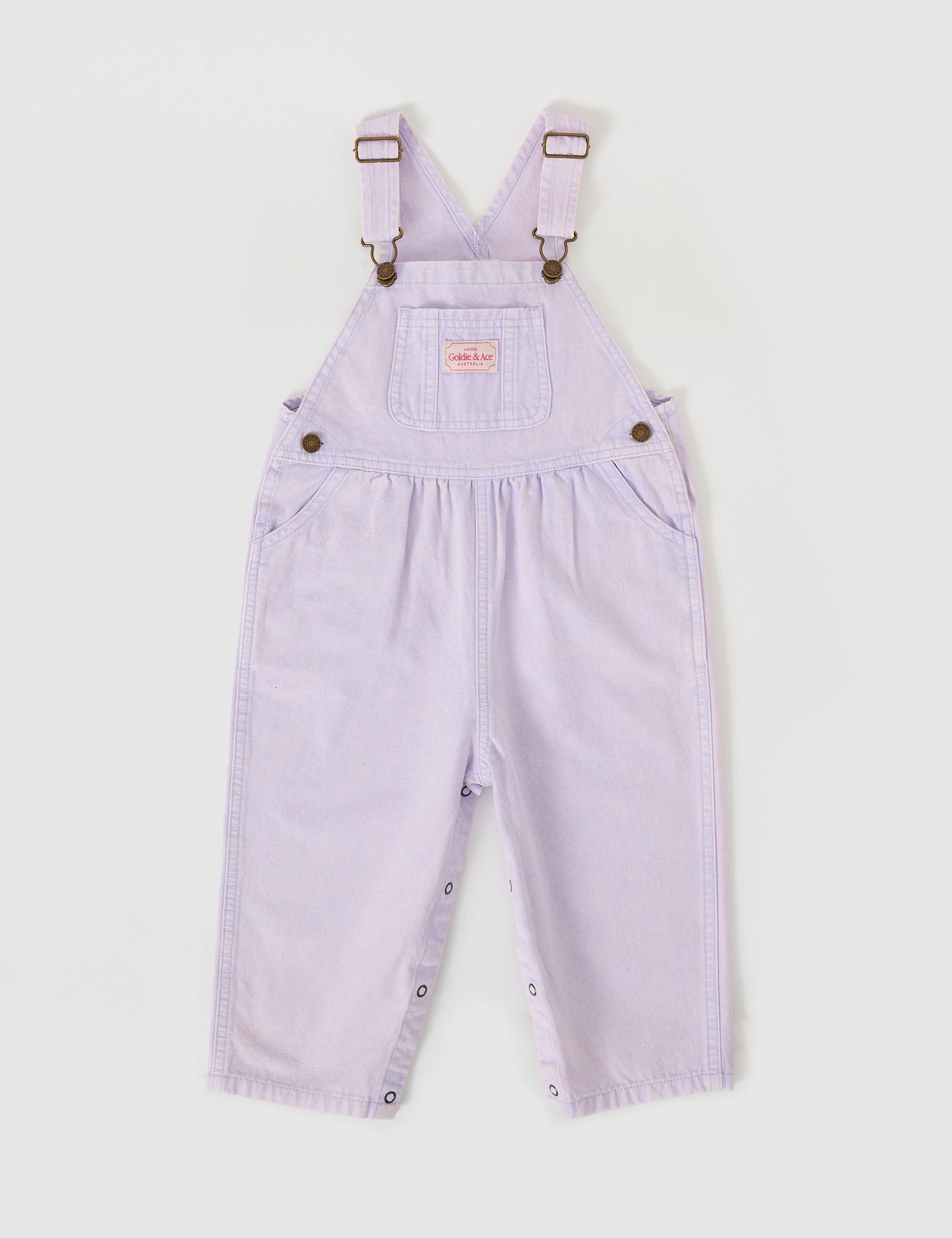 The Goldie + Ace Austin Vintage Washed Denim Overalls in Mauve pictured on a grey background. The material is cotton denim. It is a overall made for babies, toddlers and kids.