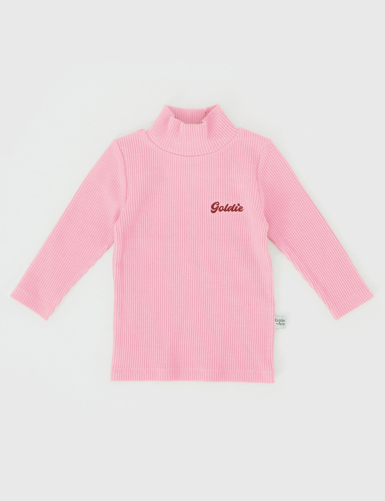 The Goldie + Ace Embroidered Rib Skivvy in Sweetpea pictured on a grey background. The material is soft ribbed cotton elastane. It is a top made for babies, toddlers and kids.