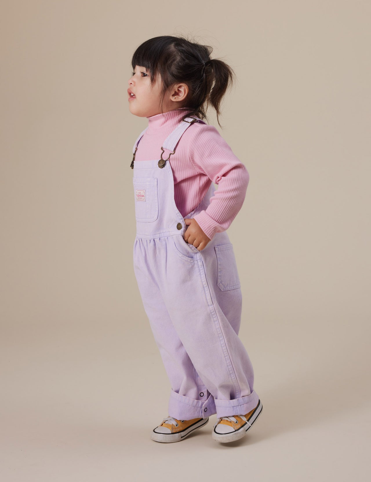 The Goldie + Ace Embroidered Rib Skivvy in Sweetpea pictured on a grey background. The material is soft ribbed cotton elastane. It is a top made for babies, toddlers and kids.