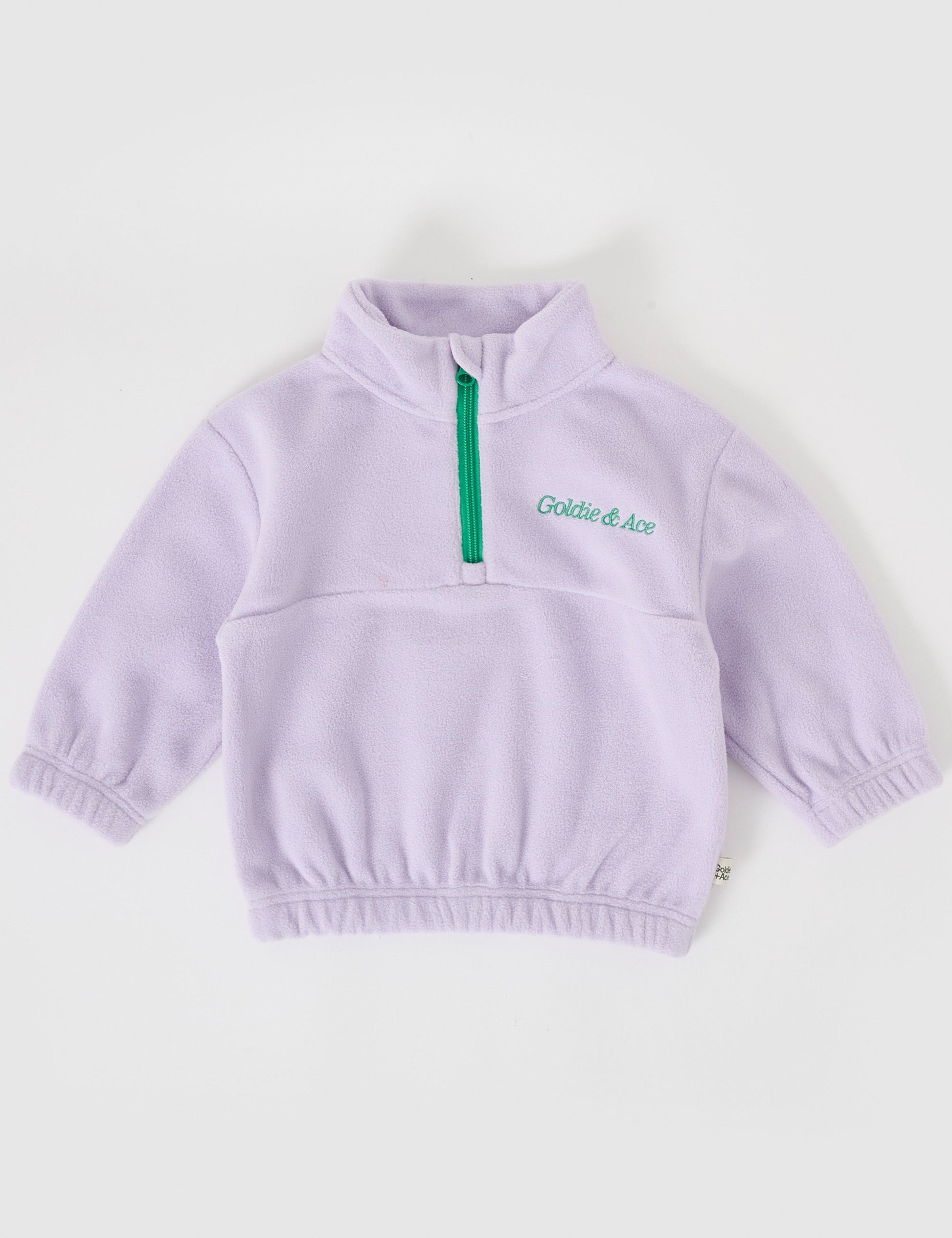 The Goldie + Ace Bobbi Polar Fleece Sweater in Lilac pictured on a grey background. The material is polyester. It is a top made for babies, toddlers and kids.