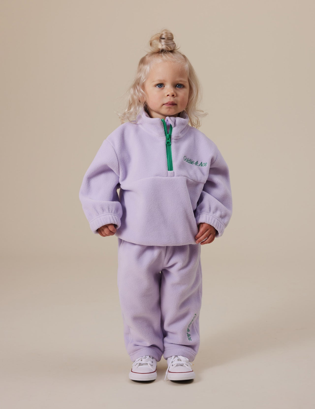 The Goldie + Ace Bobbi Polar Fleece Sweatpants in Lilac pictured on a grey background. The material is polyester. It is a bottom made for babies, toddlers and kids.