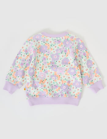 The Goldie + Ace Flora Relaxed Terry Sweater in Lilac Multi pictured on a grey background. The material is cotton terry. It is a top made for babies, toddlers and kids.