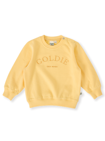 The Goldie + Ace Goldie Crew Embroidered Sweater in Lemon pictured on a transparent background. The material is 100% cotton. It is a top made for babies, toddlers and kids.
