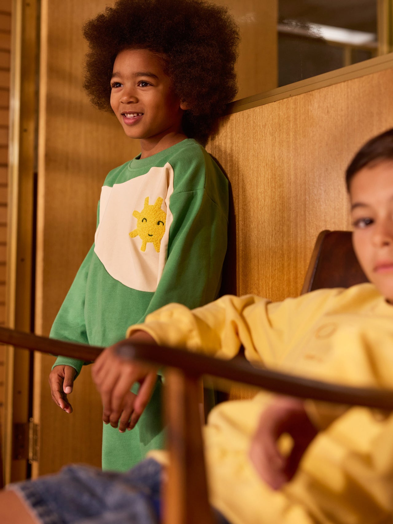 The Goldie + Ace Sunshine Piped Panel Sweatshirt in Fern/Vanilla pictured on a transparent background. The material is 100% cotton. It is a top made for babies, toddlers and kids.