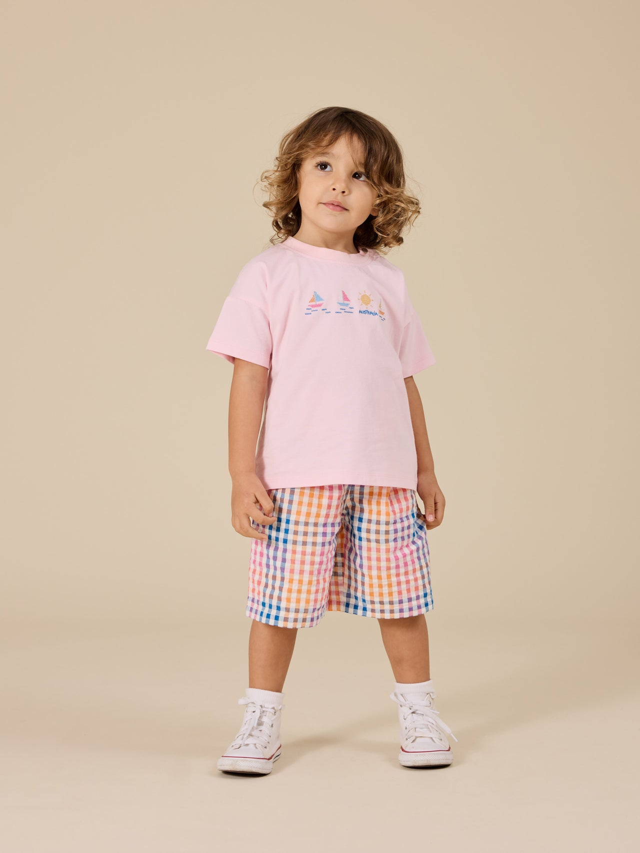 The Goldie + Ace Rainbow Gingham Kirby Relaxed Shorts in Multi pictured on a transparent background. The material is 100% cotton. It is a bottom made for babies, toddlers and kids.
