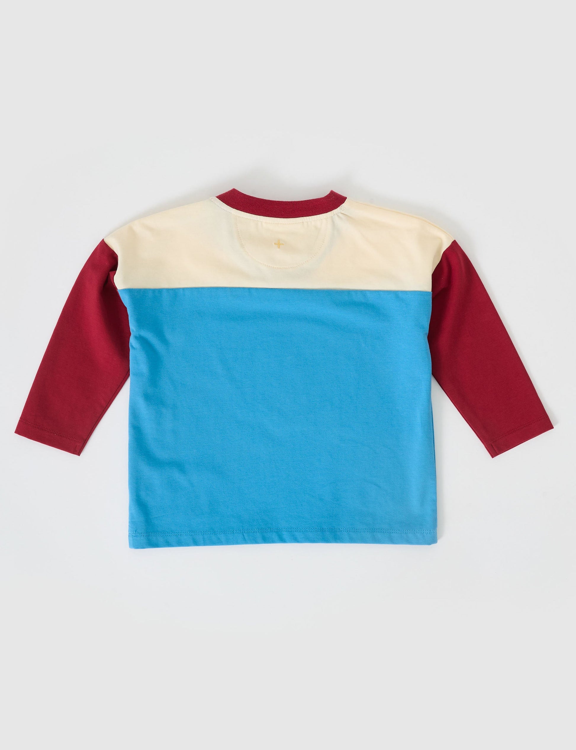 The Goldie + Ace Chip Long Sleeve Jersey in Blue/Burgundy pictured on a grey background. The material is cotton jersey. It is a top made for babies, toddlers and kids.