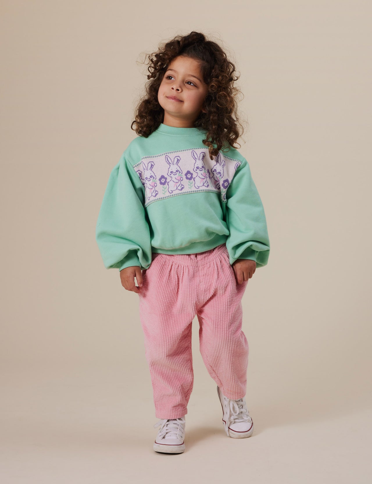 The Goldie + Ace Nora Corduroy Pant in Sweetpea pictured on a grey background. The material is cotton cord. It is a bottom made for babies, toddlers and kids.