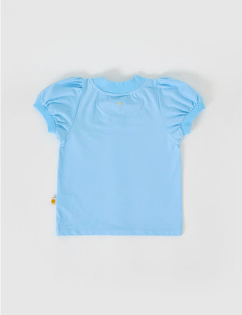 The Goldie + Ace Eden Embroidered Puff Sleeve T-Shirt in Sky Blue pictured on a grey background. The material is cotton jersey. It is a top made for babies, toddlers and kids.