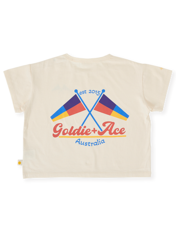 The Goldie + Ace Nautical Flag Oversized T-Shirt in Cream pictured on a transparent background. The material is 100% cotton. It is a top made for babies, toddlers and kids.