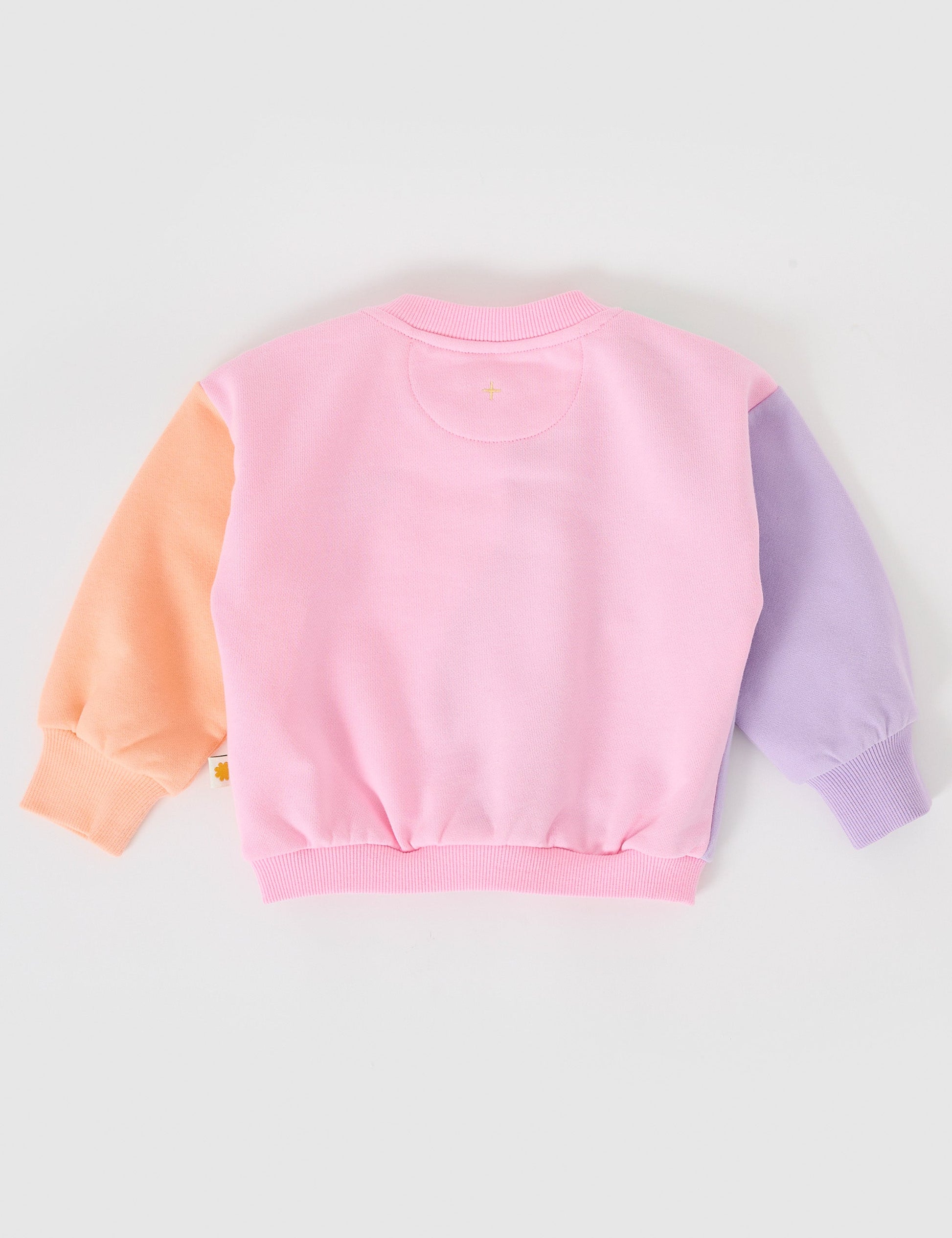 The Goldie + Ace Rio Wave Sweater Cotton Candy in Pink pictured on a grey background. The material is 100% cotton french terry. It is a top made for babies, toddlers and kids.