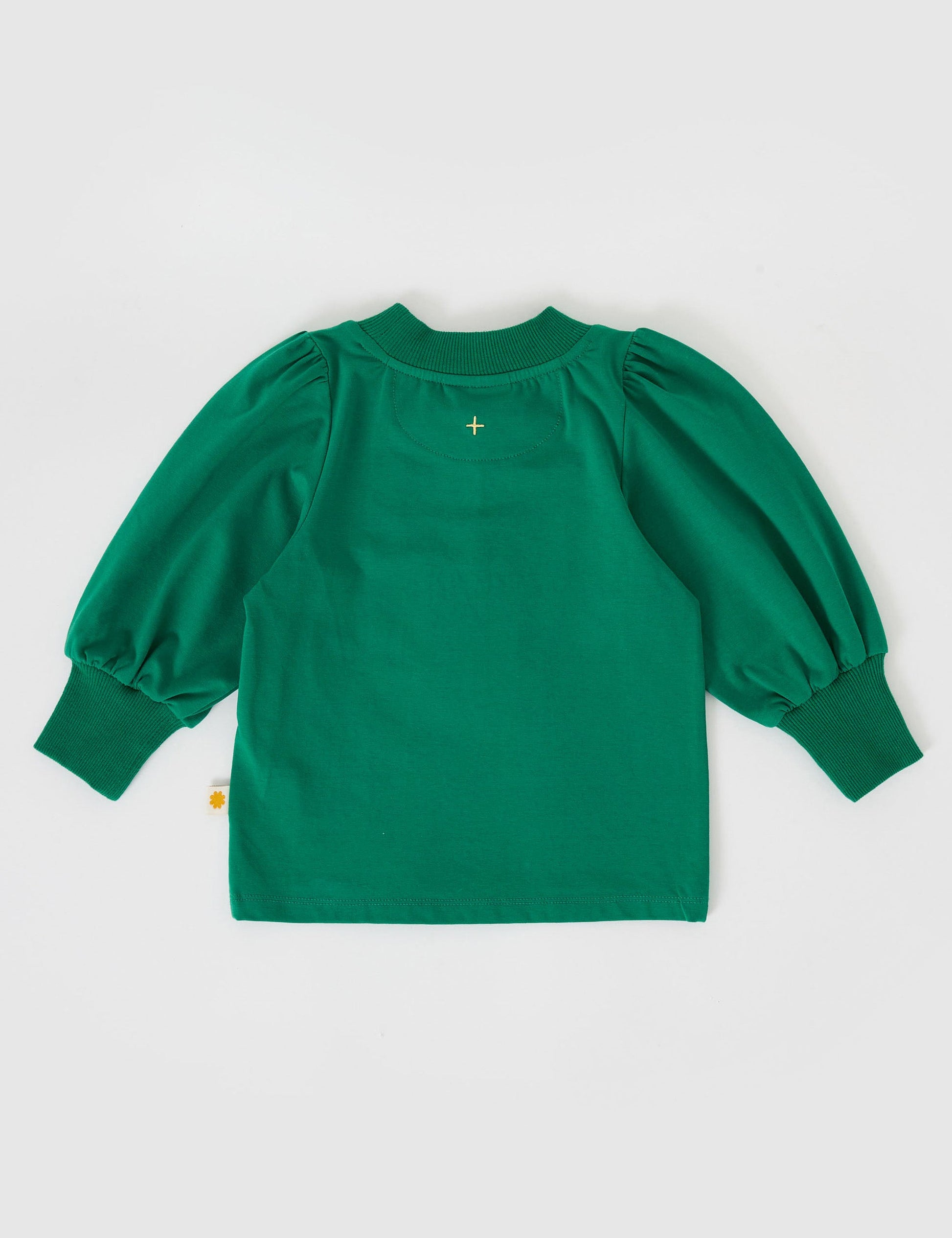 The Goldie + Ace Eden Embroidered Puff Sleeve Top in Bottle Green pictured on a grey background. The material is cotton jersey. It is a top made for babies, toddlers and kids.