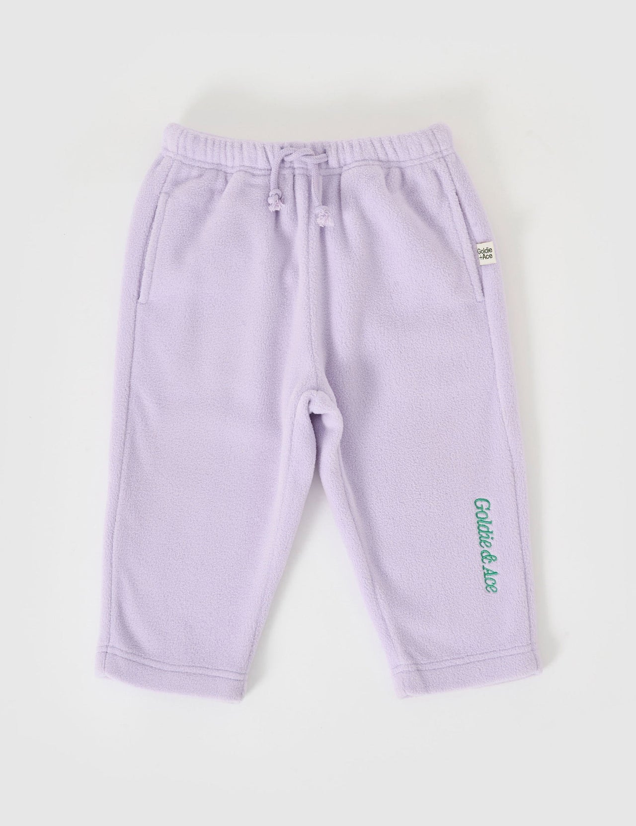 The Goldie + Ace Bobbi Polar Fleece Sweatpants in Lilac pictured on a grey background. The material is polyester. It is a bottom made for babies, toddlers and kids.