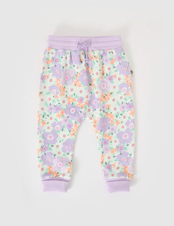 The Goldie + Ace Flora Terry Sweatpants in Lilac Multi pictured on a grey background. The material is cotton terry. It is a bottom made for babies, toddlers and kids.