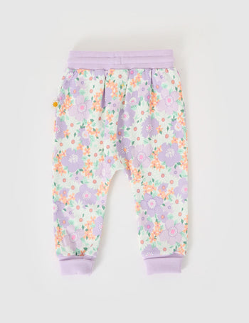 The Goldie + Ace Flora Terry Sweatpants in Lilac Multi pictured on a grey background. The material is cotton terry. It is a bottom made for babies, toddlers and kids.