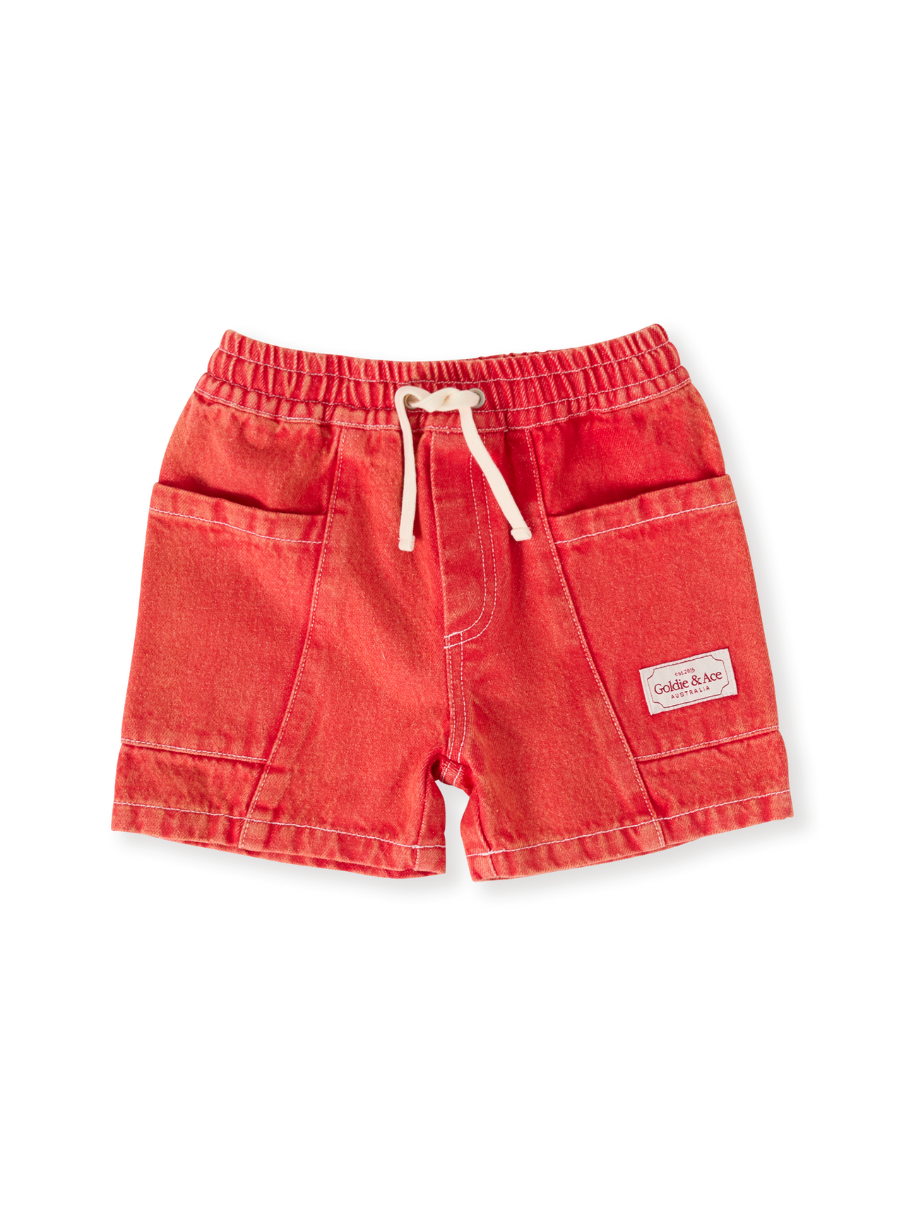 The Goldie + Ace Noah Denim Pocket Shorts in Apple Red pictured on a transparent background. The material is 100% cotton. It is a bottom made for babies, toddlers and kids.