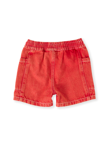 The Goldie + Ace Noah Denim Pocket Shorts in Apple Red pictured on a transparent background. The material is 100% cotton. It is a bottom made for babies, toddlers and kids.