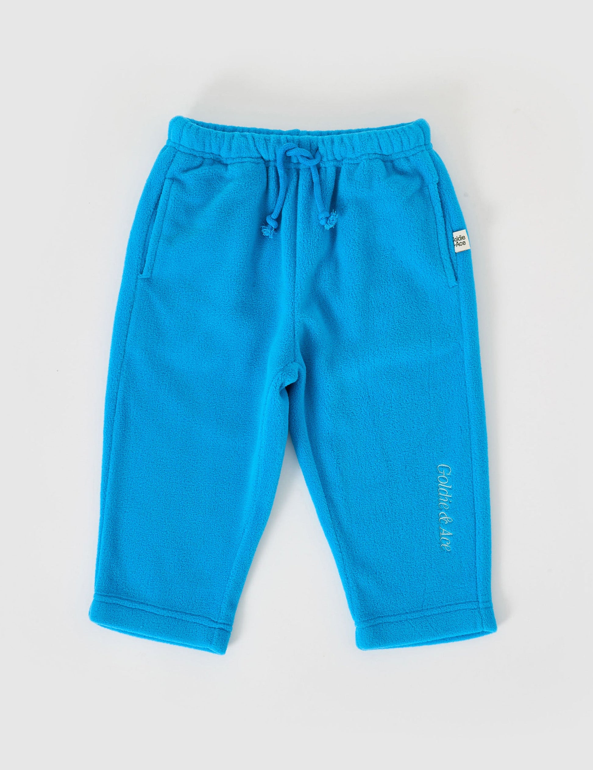 The Goldie + Ace Bobbi Polar Fleece Sweatpants in Lake pictured on a grey background. The material is polyester. It is a bottom made for babies, toddlers and kids.