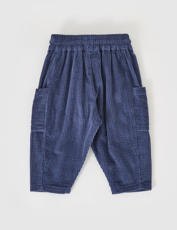 The Goldie + Ace Kit Corduroy Pocket Pant in Navy pictured on a grey background. The material is cotton cord. It is a bottom made for babies, toddlers and kids.