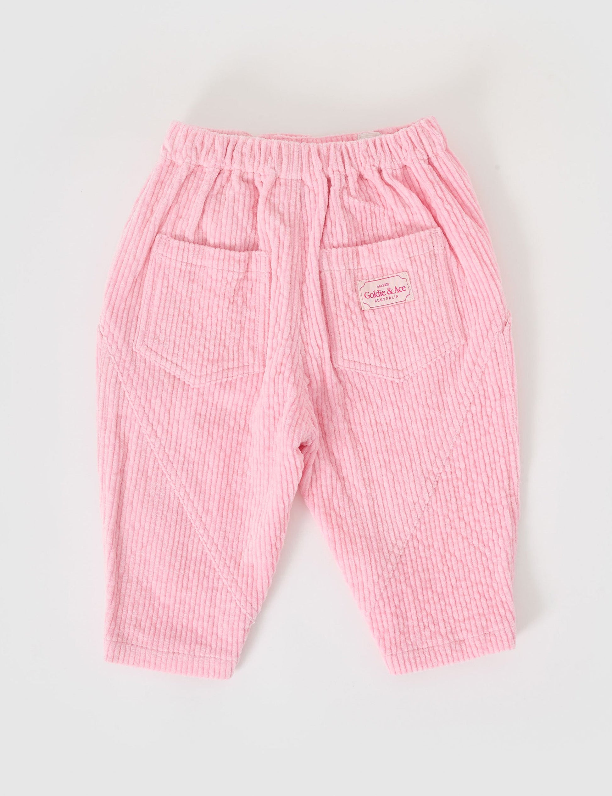 The Goldie + Ace Nora Corduroy Pant in Sweetpea pictured on a grey background. The material is cotton cord. It is a bottom made for babies, toddlers and kids.