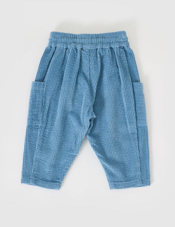 The Goldie + Ace Kit Corduroy Pocket Pant in Duck Egg pictured on a grey background. The material is cotton cord. It is a bottom made for babies, toddlers and kids.