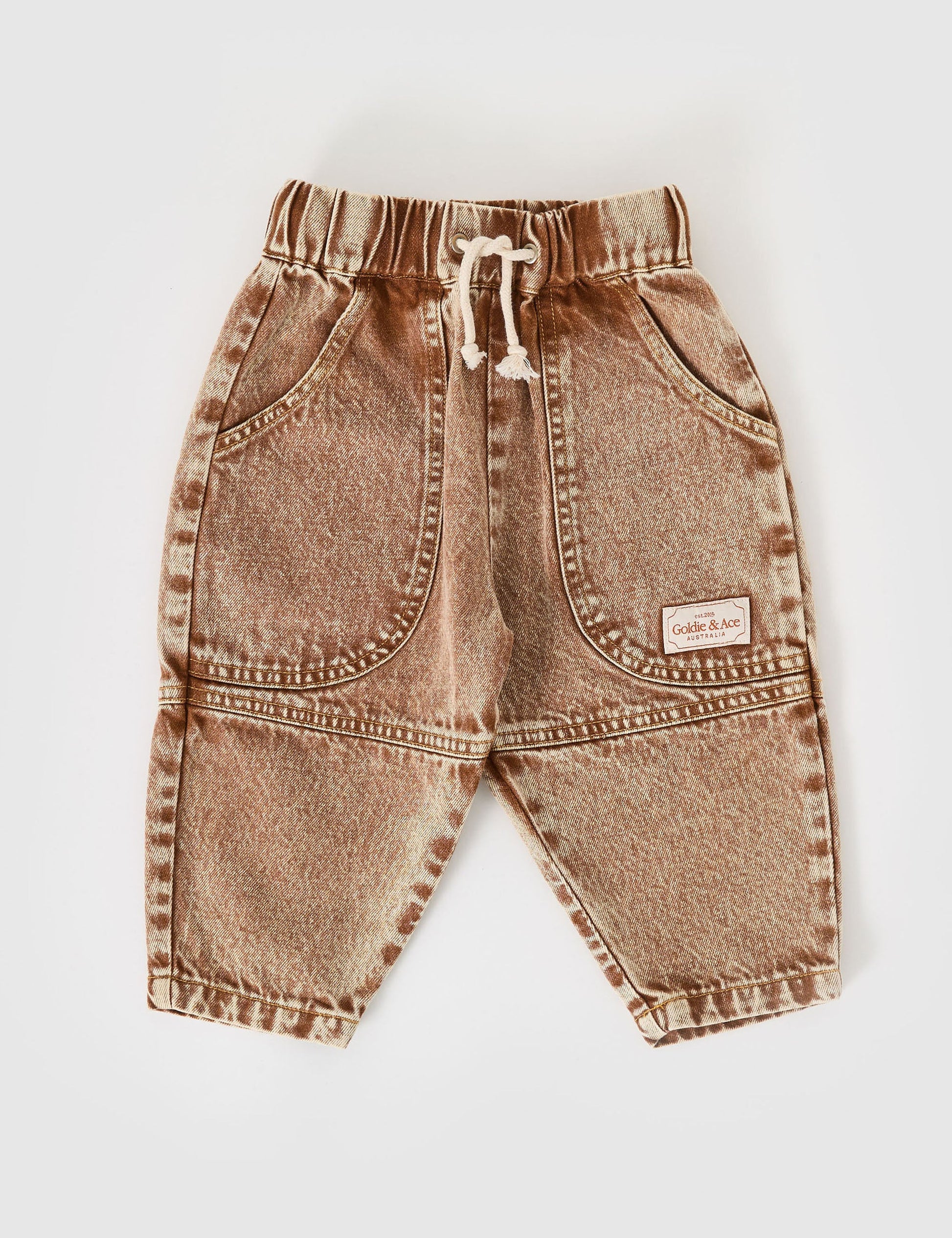 The Goldie + Ace Drew Denim Pocket Pant in Brown pictured on a grey background. The material is cotton denim. It is a bottom made for babies, toddlers and kids.