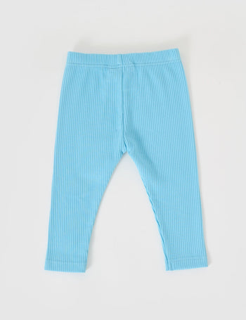 The Goldie + Ace Bowie Rib Legging in Sky Blue pictured on a grey background. The material is soft cotton elastane. It is a bottom made for babies, toddlers and kids.