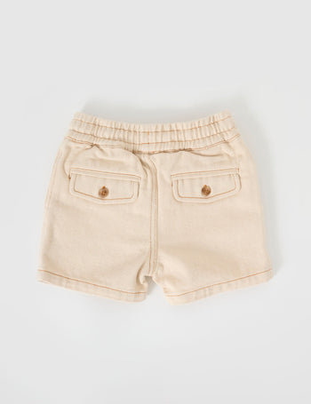 The Goldie + Ace Noah Denim Shorts in Oat pictured on a grey background. The material is cotton twill. It is a bottom made for babies, toddlers and kids.