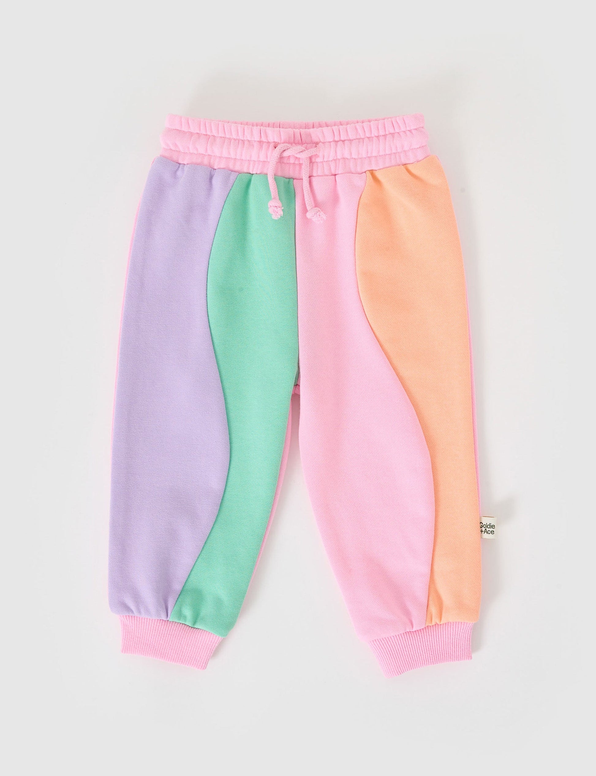 The Goldie + Ace Rio Wave Terry Sweatpants Cotton Candy in Pink pictured on a grey background. The material is 100% cotton french terry. It is a bottom made for babies, toddlers and kids.
