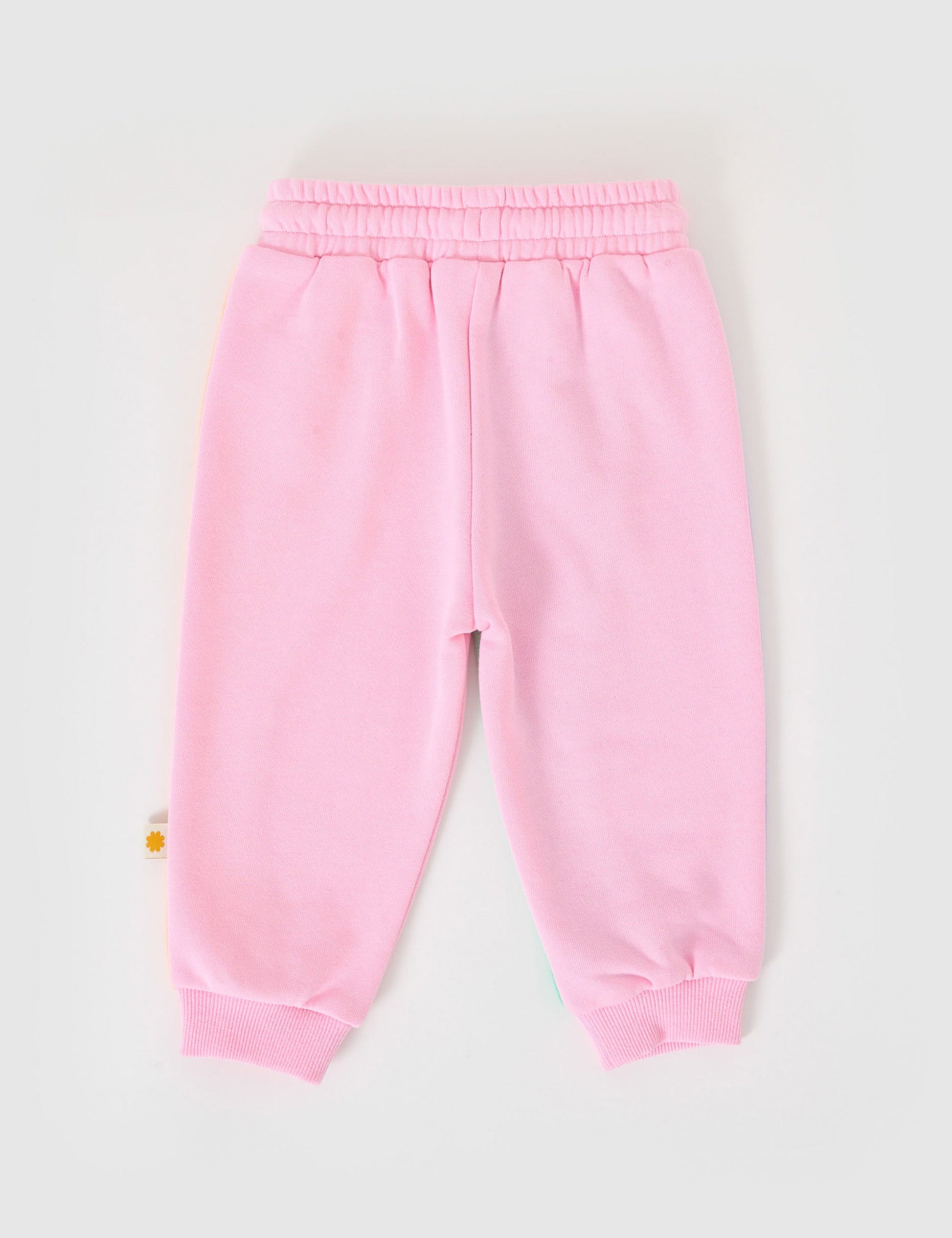The Goldie + Ace Rio Wave Terry Sweatpants Cotton Candy in Pink pictured on a grey background. The material is 100% cotton french terry. It is a bottom made for babies, toddlers and kids.