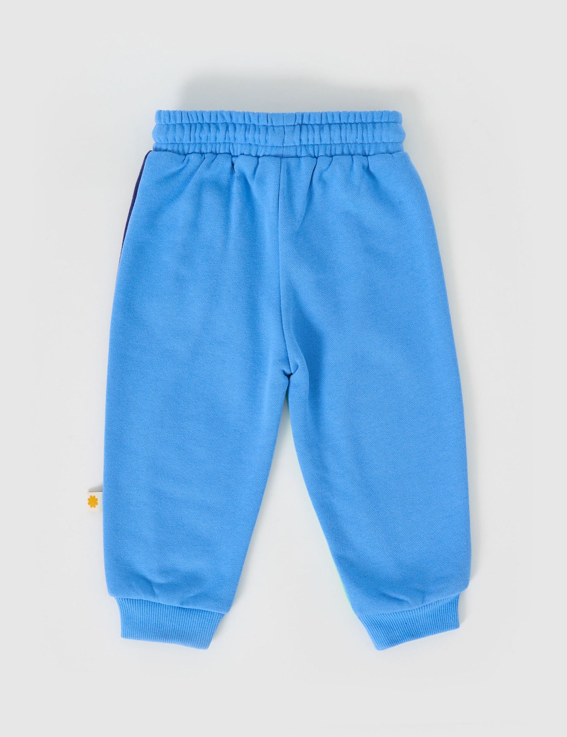 The Goldie + Ace Rio Wave Terry Sweatpants Ocean Blue in Blue pictured on a grey background. The material is 100% cotton french terry. It is a bottom made for babies, toddlers and kids.