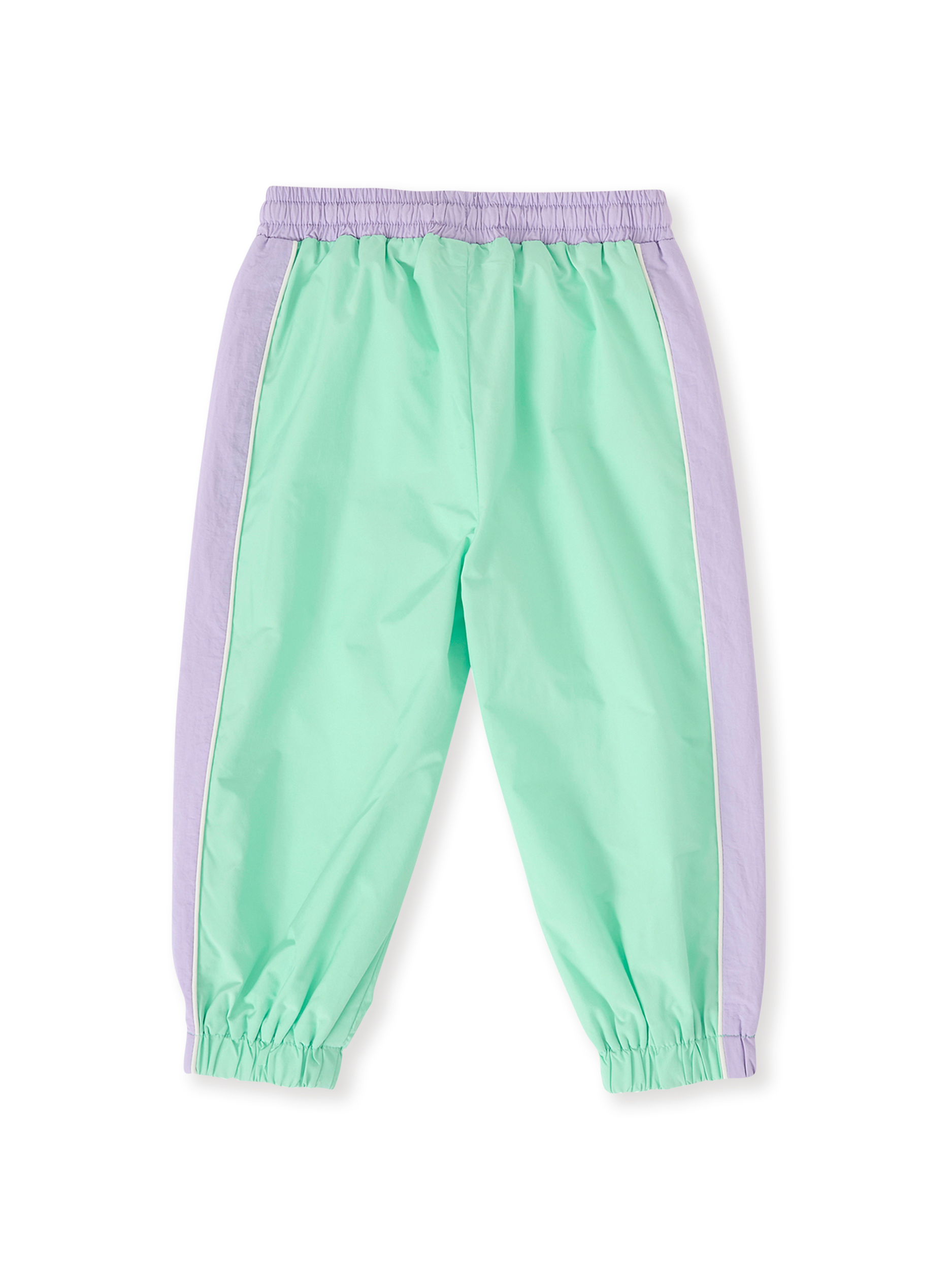 The Goldie + Ace Retro Sporty Pants in Peapod/Lilac pictured on a transparent background. The material is poly with cotton lining. It is a bottom made for babies, toddlers and kids.