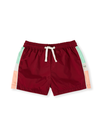 The Goldie + Ace Retro Sporty Shorts in Brick/Peapod pictured on a transparent background. The material is poly with cotton lining. It is a bottom made for babies, toddlers and kids.