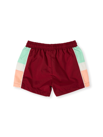 The Goldie + Ace Retro Sporty Shorts in Brick/Peapod pictured on a transparent background. The material is poly with cotton lining. It is a bottom made for babies, toddlers and kids.
