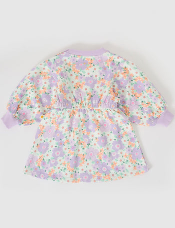 The Goldie + Ace Flora Leah Long Sleeve Dress in Lilac Multi pictured on a grey background. The material is cotton terry. It is a dress made for babies, toddlers and kids.