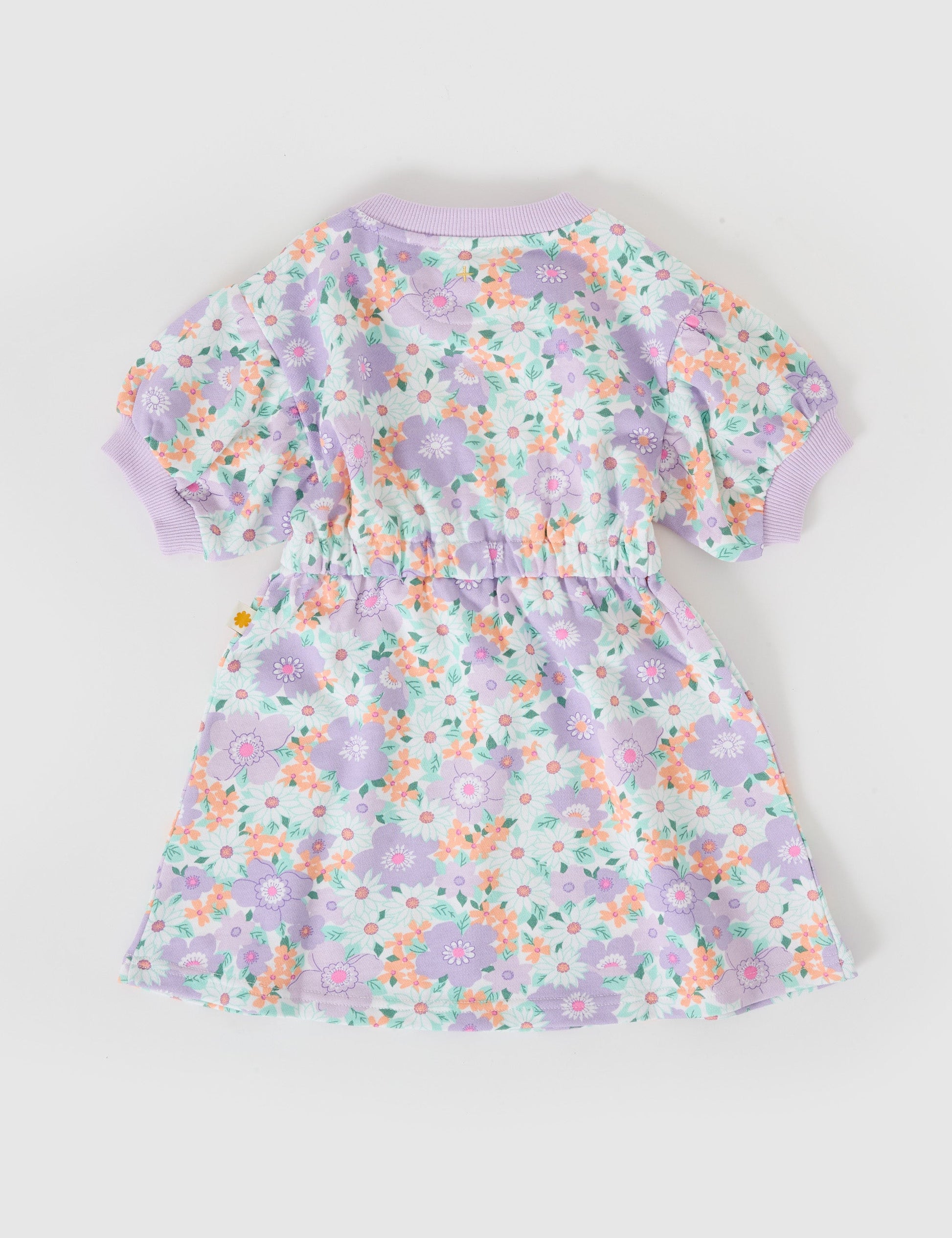 The Goldie + Ace Flora Molly Short Sleeve Dress in Lilac Multi pictured on a grey background. The material is cotton terry. It is a dress made for babies, toddlers and kids.