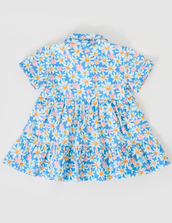 The Goldie + Ace Seaside Daisy Monica Dress in Seaside Daisy pictured on a grey background. The material is cotton twill. It is a dress made for babies, toddlers and kids.