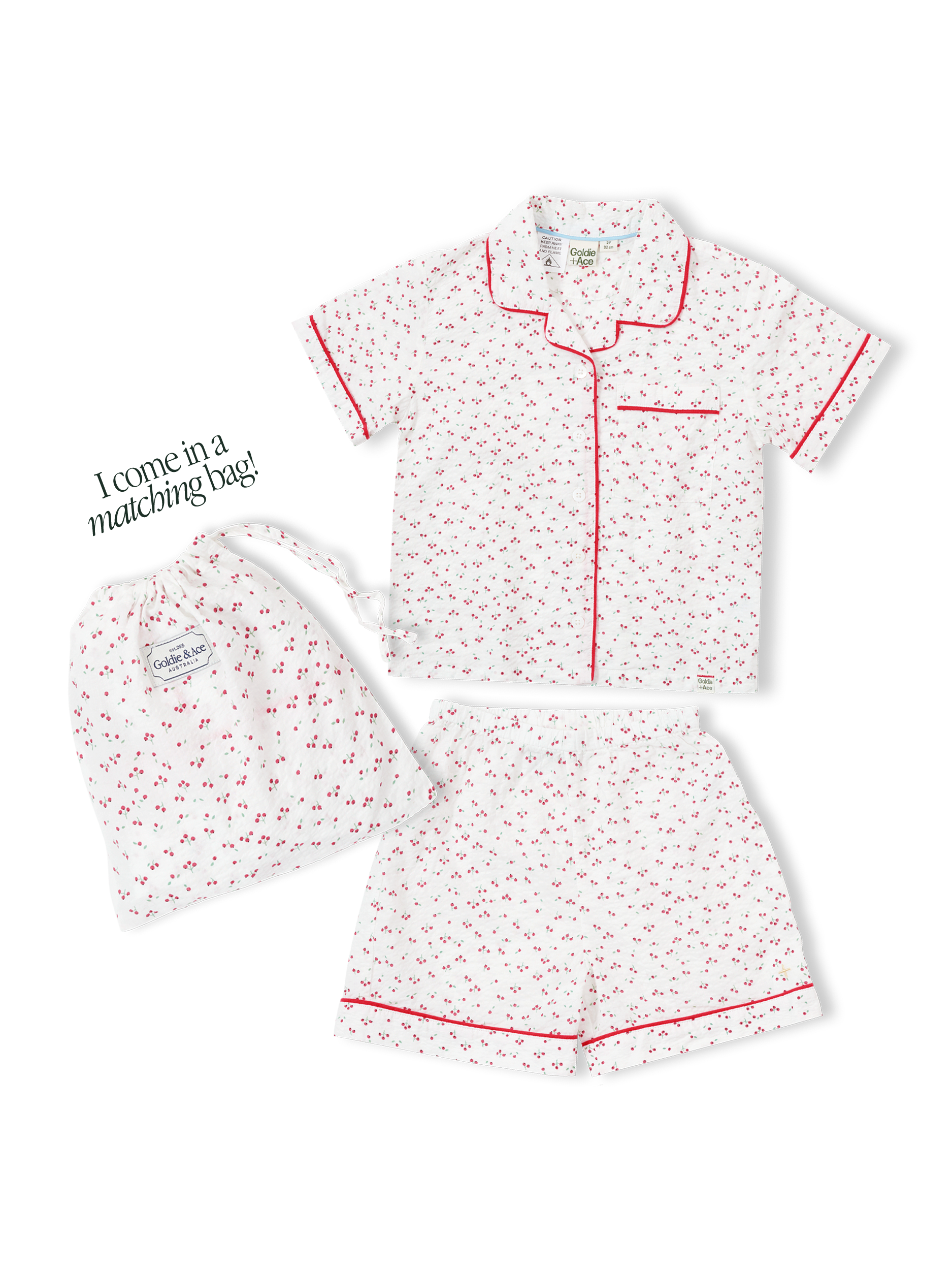 Children's pyjama set with cherry print on seersucker cotton, and a matching drawstring bag