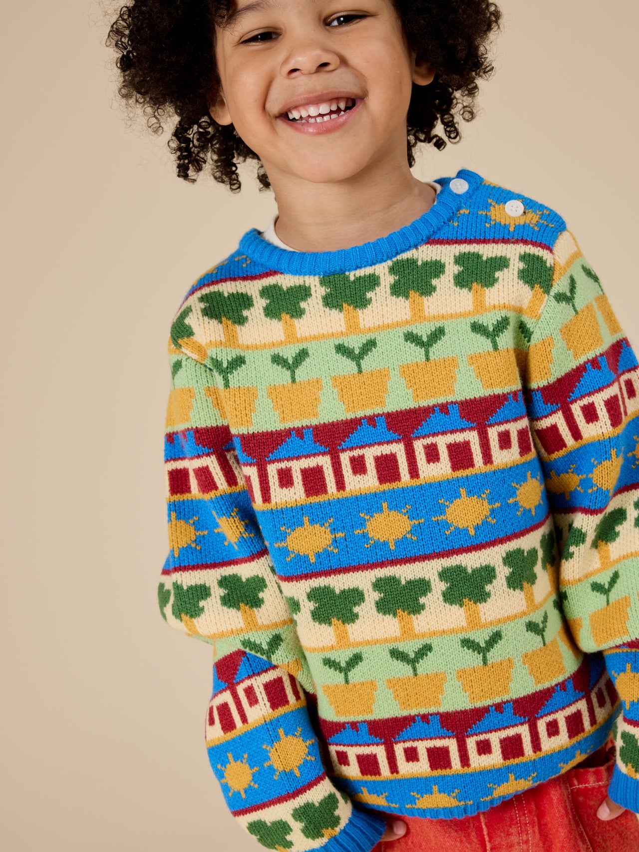 The Goldie + Ace Among The Gumtrees Knit Jumper in Blue Multi pictured on a transparent background. The material is soft knit made from wool, acrylic, and nylon. It is a knit made for babies, toddlers and kids.