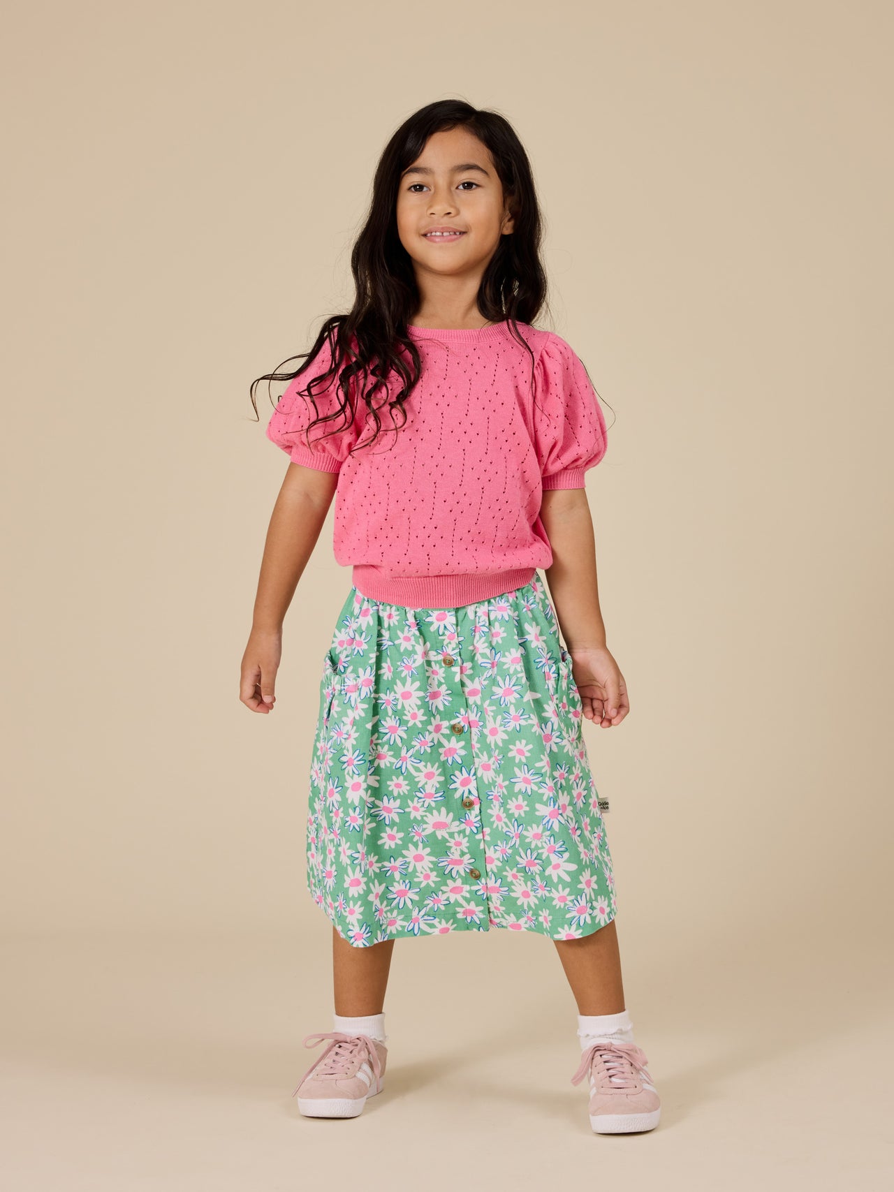 The Goldie + Ace Pointelle Puff Knit Top in Pink Lemonade pictured on a transparent background. The material is 100% cotton. It is a knit made for babies, toddlers and kids.
