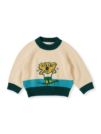 The Goldie + Ace Marley Koala Knit Jumper in Vanilla/Teal pictured on a transparent background. The material is soft acrylic blend with wool and nylon. It is a top made for babies, toddlers and kids.