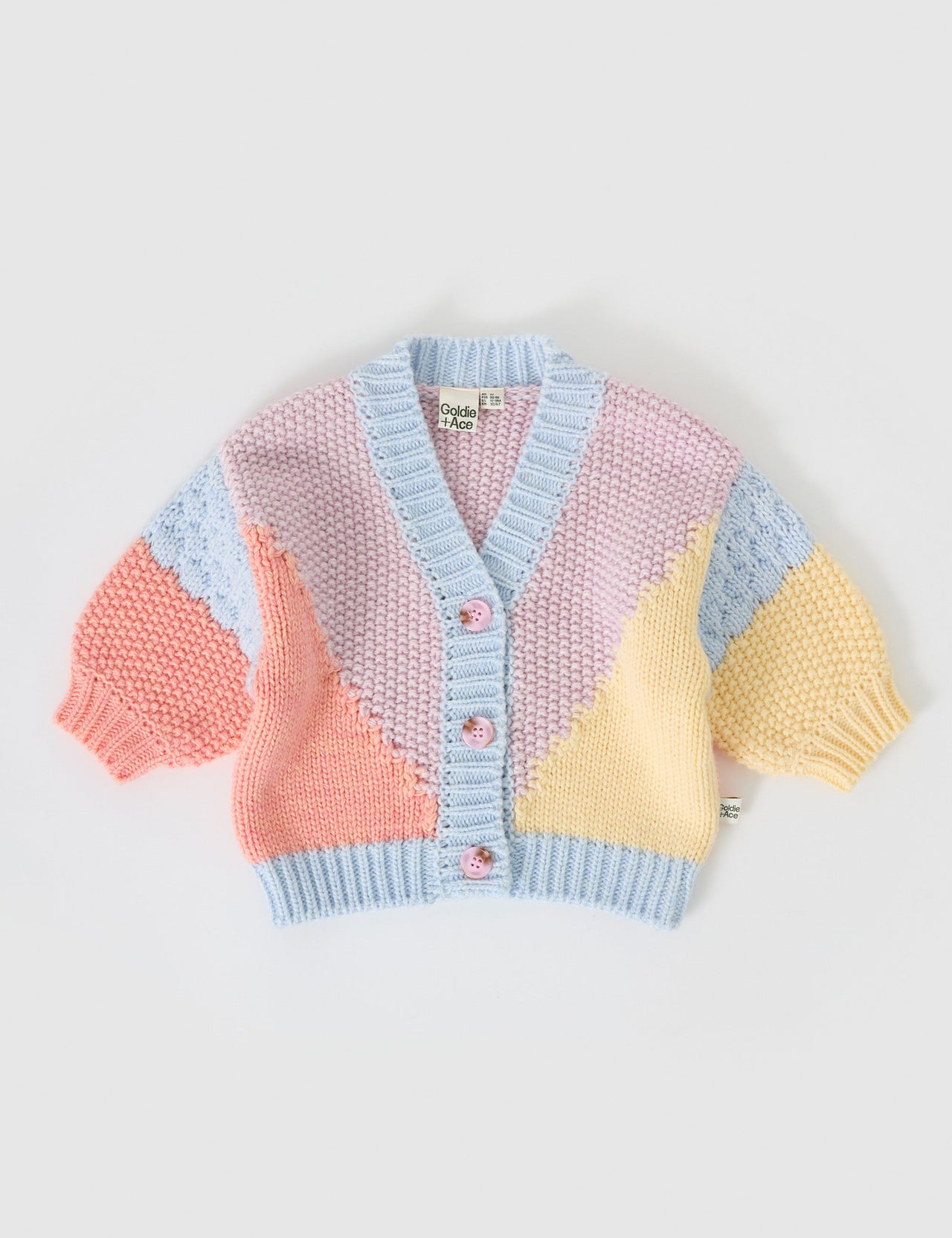 The Goldie + Ace Colour Block Knit Cardigan in Blue/Pink pictured on a grey background. The material is super soft wool blend. It is a knit made for babies, toddlers and kids.