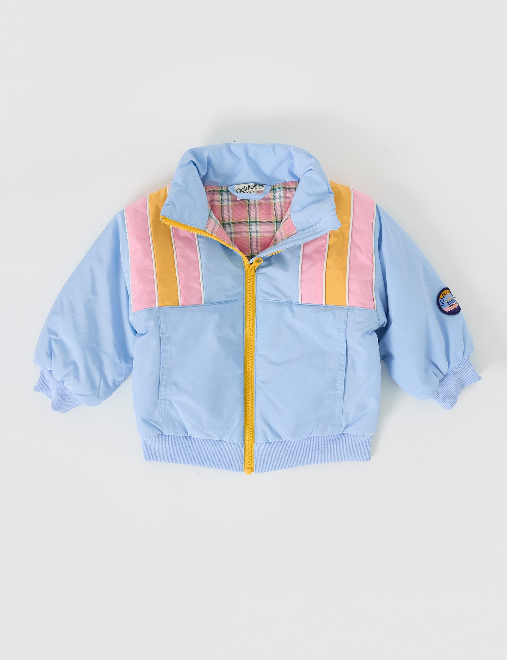 The Goldie + Ace Jordan Jacket in Sky Blue/Pink pictured on a grey background. The material is poly with poly lining. It is a jacket made for babies, toddlers and kids.