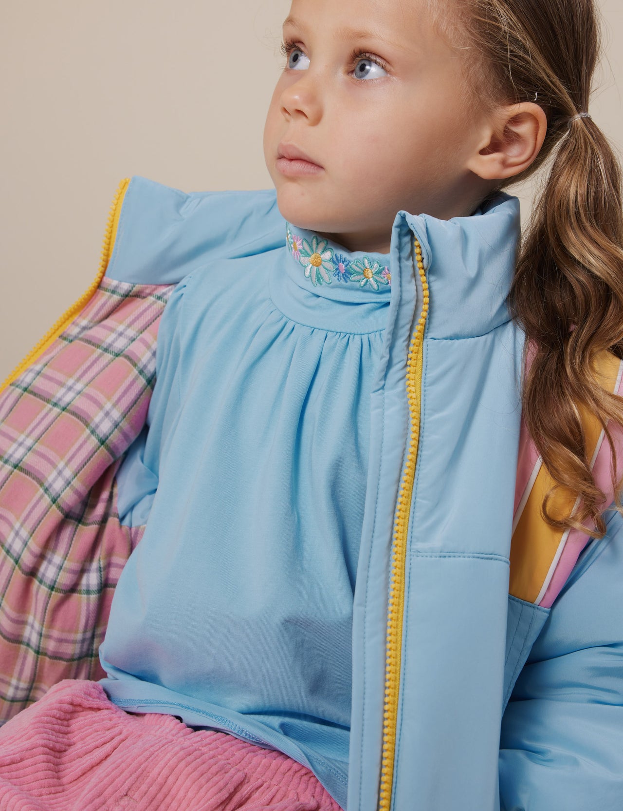 The Goldie + Ace Jordan Jacket in Sky Blue/Pink pictured on a grey background. The material is poly with poly lining. It is a jacket made for babies, toddlers and kids.
