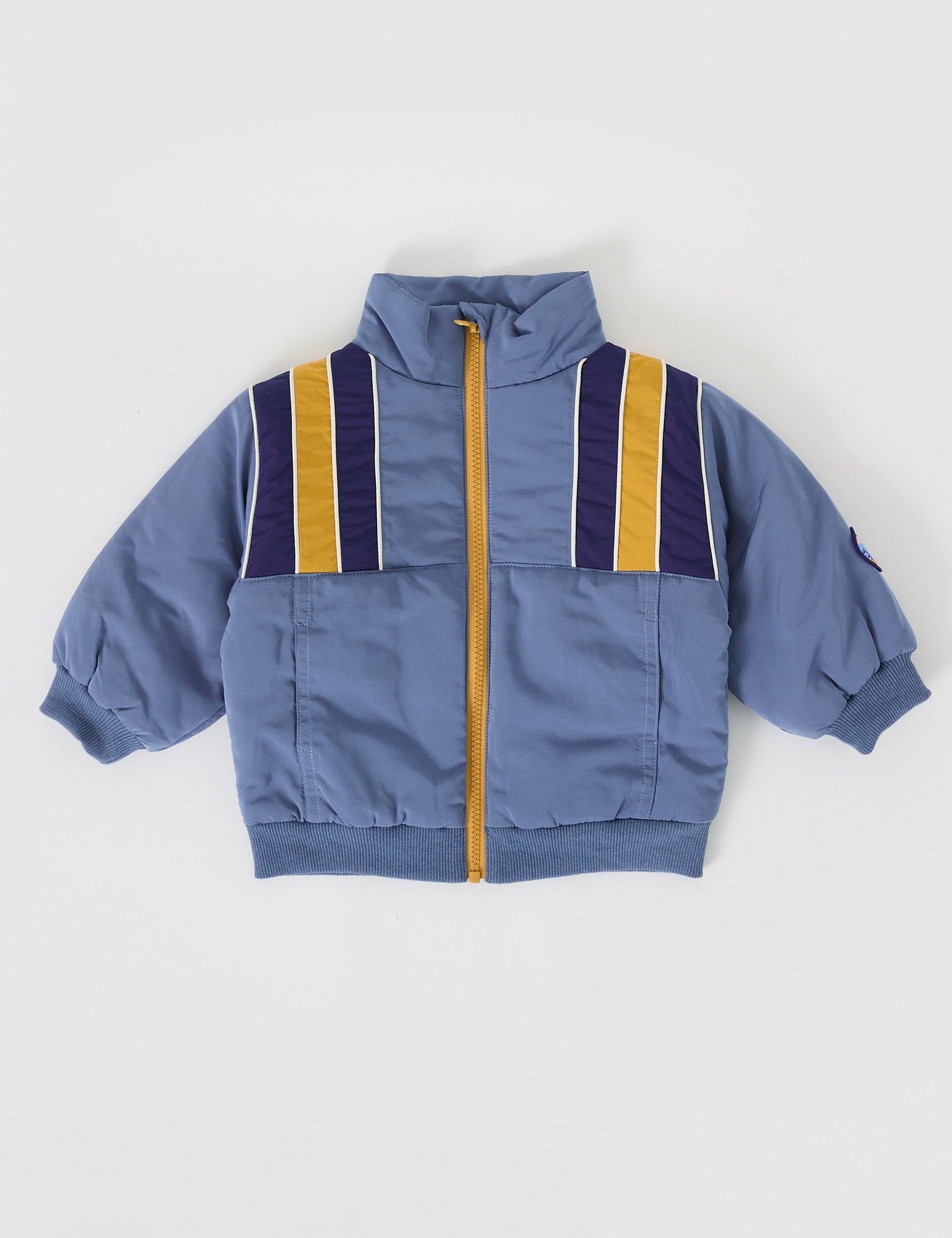 The Goldie + Ace Jordan Jacket in Duck Egg/Golden pictured on a grey background. The material is poly with poly lining. It is a jacket made for babies, toddlers and kids.