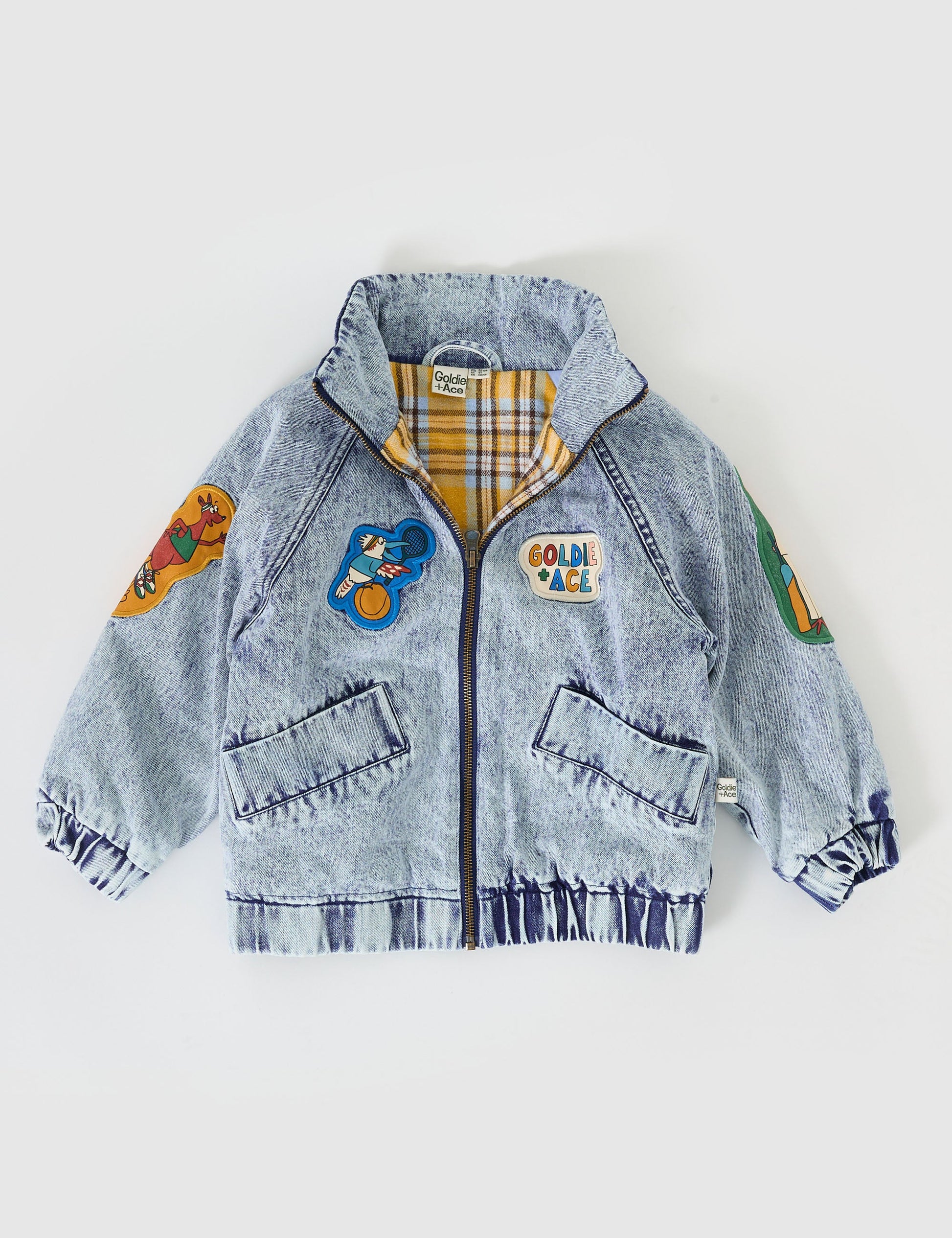 The Goldie + Ace Ari Denim Jacket in Blue Denim pictured on a grey background. The material is denim with poly sherpa lining. It is a jacket made for babies, toddlers and kids.